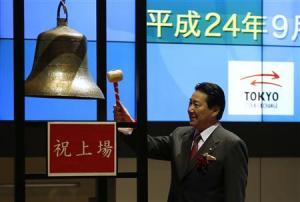 JAL President Ueki rings a bell during a ceremony to mark the company's debut on the Tokyo Stock Exchange in Tokyo